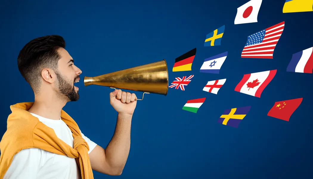 Homme qui parle dans un porte-voix d'où sortent des drapeaux de plusieurs pays